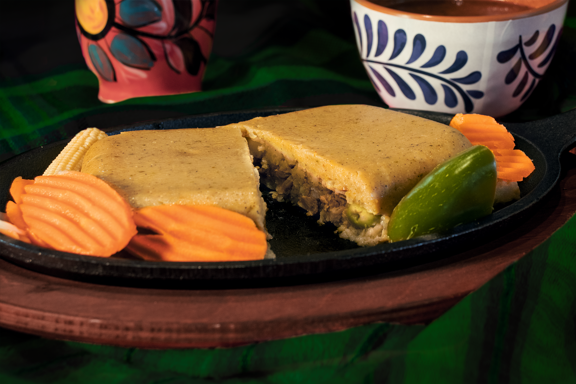 mexican central american style tamale nacatamal close up with olives green peas rice and garbanzo high protein served with encurtido